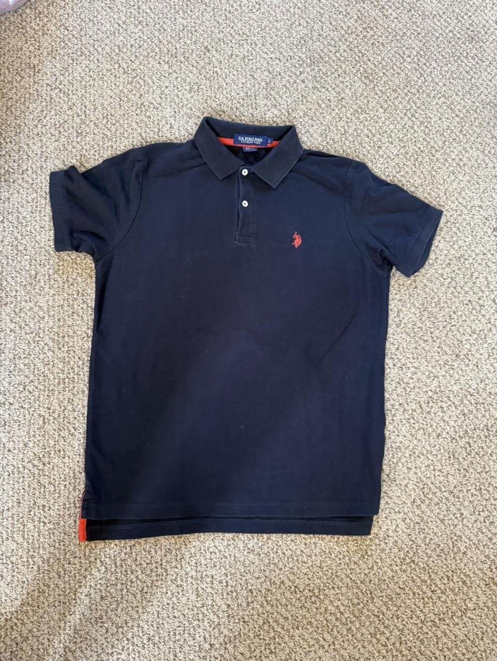 black U.S. Polo Assn. polo shirt with red logo